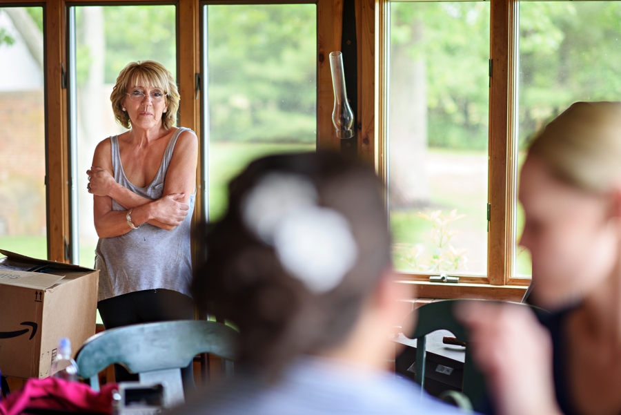 A mother watches her daughter get her makeup done on her wedding day.